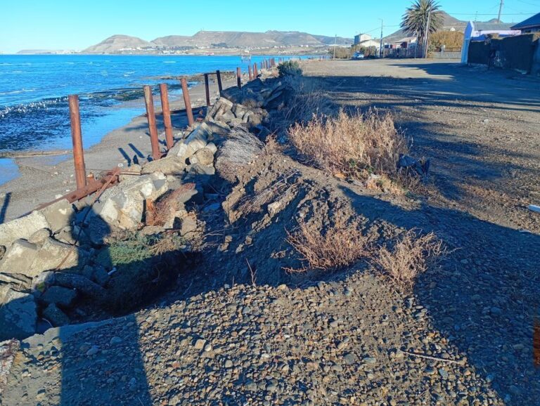 Costa erosionada en el barrio Usina de Comodoro Rivadavia, con vista al mar y camino afectado